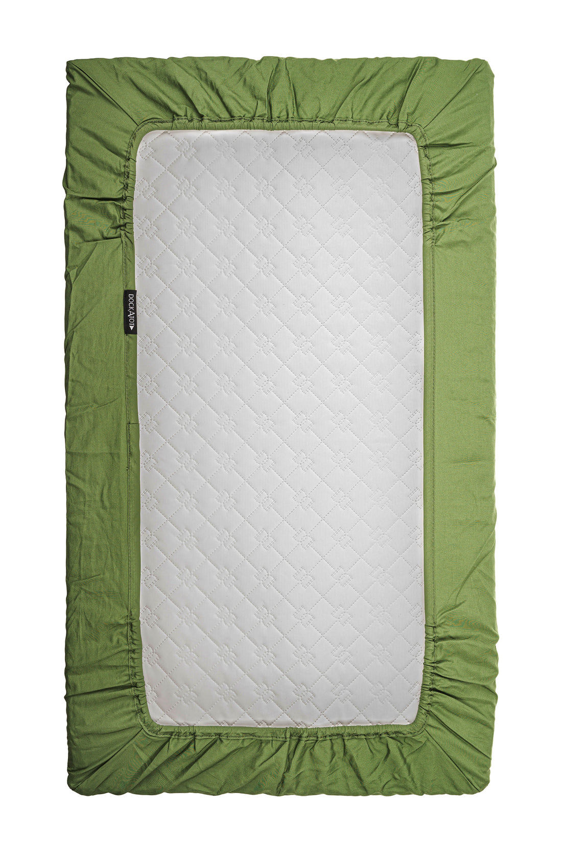 A green, fabric-bordered DockATot Sorona foam core mattress isolated on a white background. The mattress features a central white quilted section, zipper on one side, and a visible brand tag.